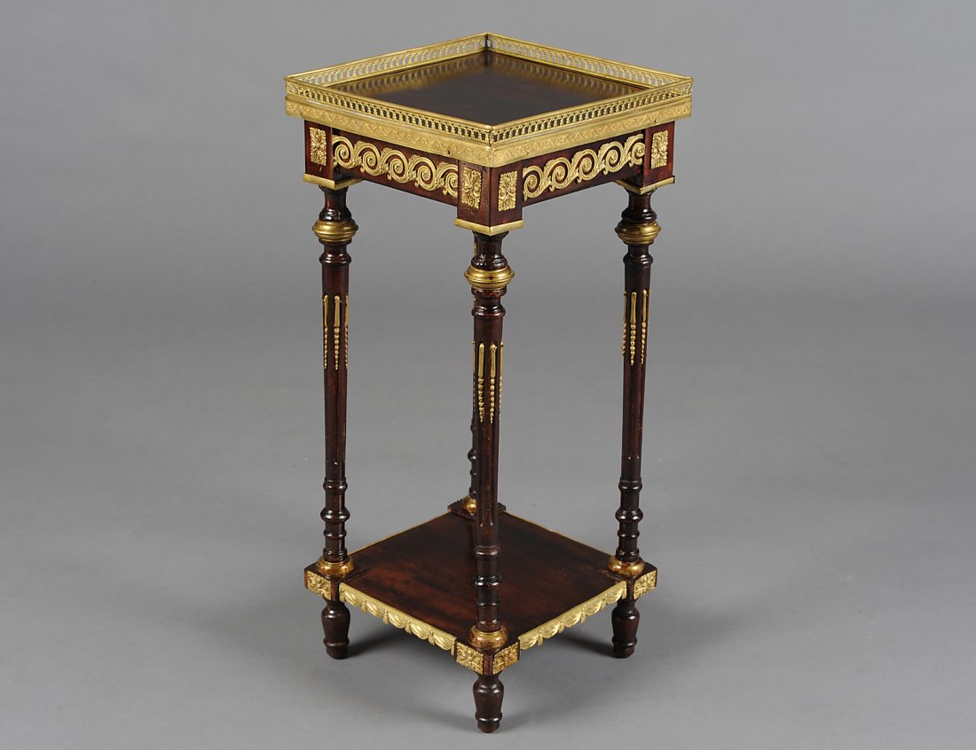 LOUIS XVI STYLE GILT BRONZE MOUNTED PEDESTAL: The square top with pierced gallery raised on circular tapering reeded legs joined by a platform stretcher. Height 27”. Width 12. Depth 12”. (300/400)