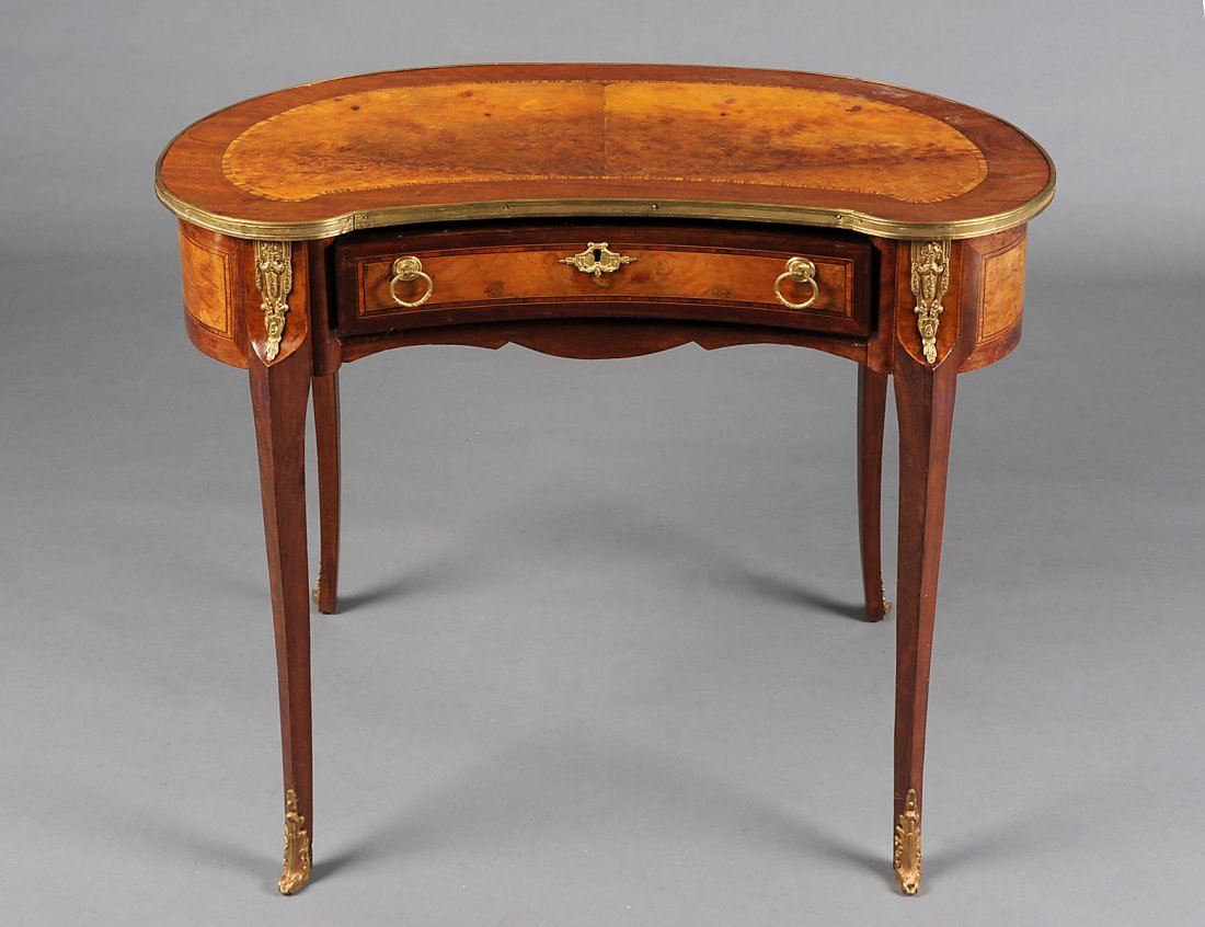 LOUIS XV STYLE BURL AND MAHOGANY LADIES DESK: French. Early 20th Century. The kidney shaped top above a frieze drawer, raised on slightly shaped legs ending in gilt bronze sabots. Height 30 ½”. Width 35 ½”. Depth 21 ¾”. (700/900)