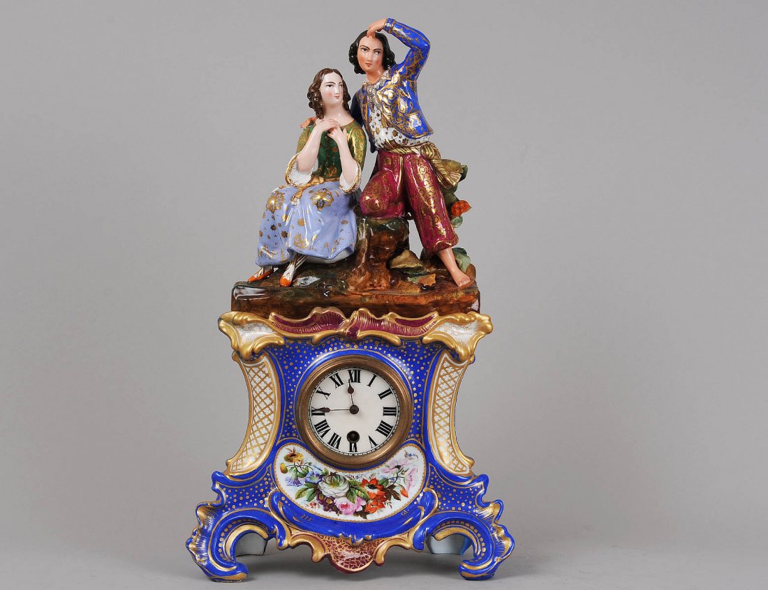 PARIS PORCELAIN MANTEL CLOCK: French. 19th Century. The scroll form case surmounted by a young woman and a man. Height 19 1/2". (Cond: restoration to case) (600/800)