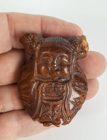 Japanese Boxwood Carved Netsuke, Study of a Young Child with lucky symbol, 20th Century, 2" x 1