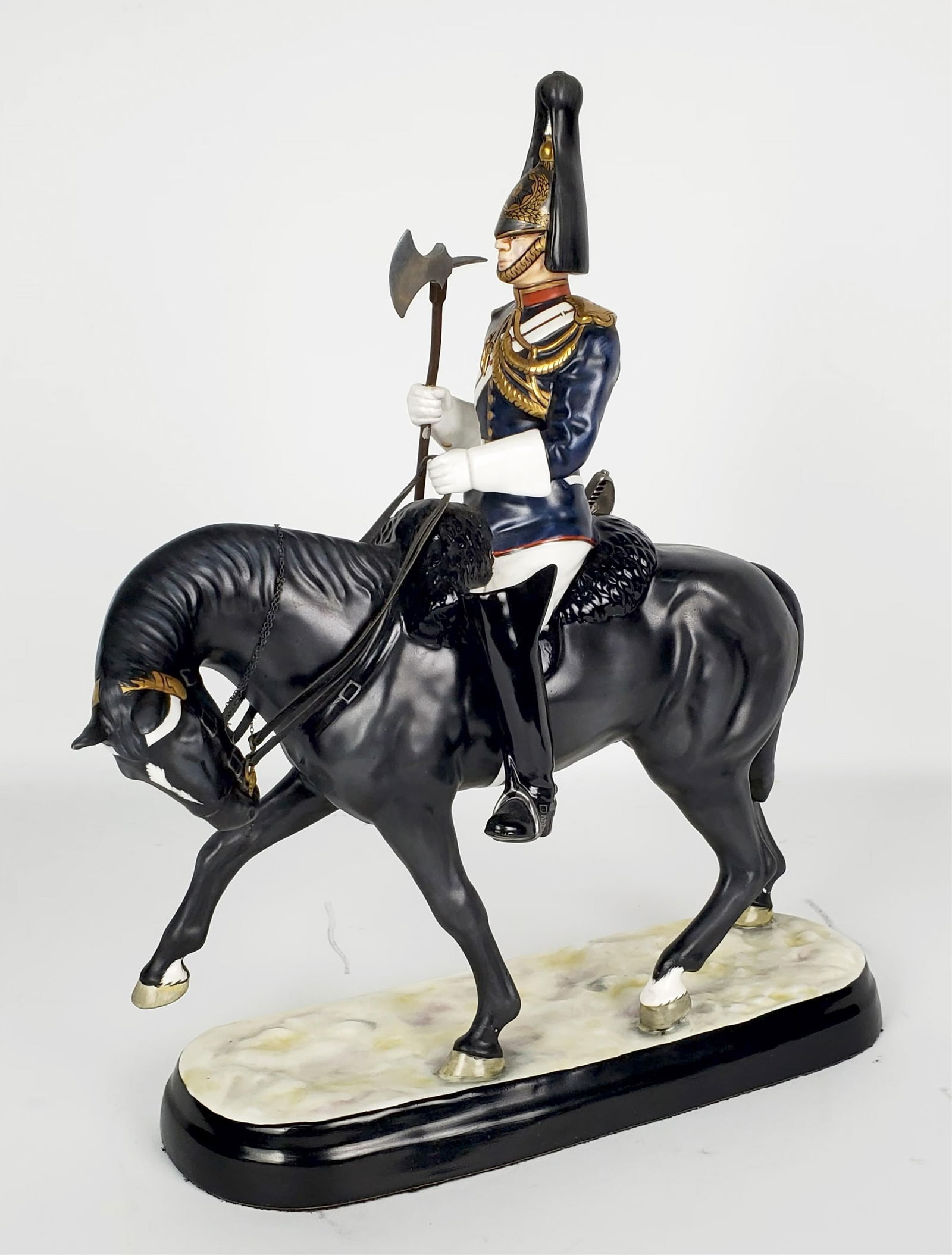 A Michael Sutty (1937-2003) English Hand Painted Porcelain Bone China Group, of Farrier Corporal: A Michael Sutty (1937-2003) English Hand Painted Porcelain Bone China Group, of Farrier Corporal Major, underside marked No.4 from and edition of 50, 15" h. 12" w. 4" d. has a repair.