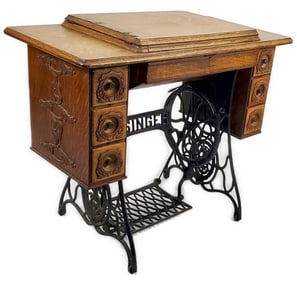 Antique Singer Sewing Stand, circa 1900, the English oak cabinet with flanking drawers and with iron
