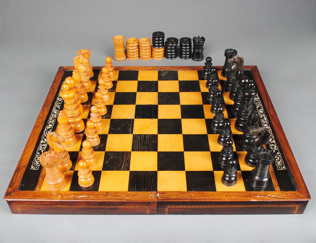 BOXWOOD AND EBONIZED WOOD PLAYING SET: English. Late 19th Century. In the "St. George" style. Height of king 6 1/2". Height of pawn 3 1/8". (Cond: numerous chips and cracks). With bone inlaid satinwood and ebony board box. Interior with ba