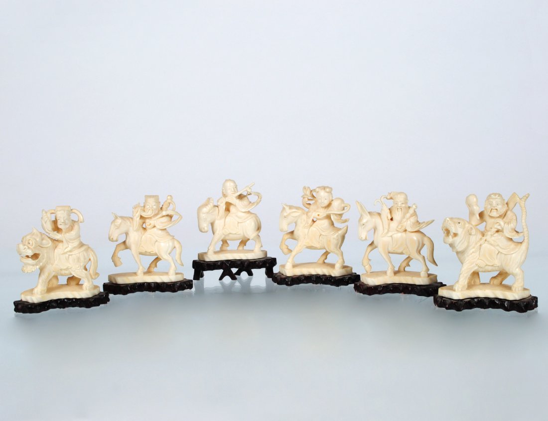GROUP OF SIX CARVED IVORY RIDERS: Chinese. Each depicting an immortal riding a mythological beast. Height 2 7/8”. Mounted on wood stands. (Cond: one beast with loss to ear) (250/350)