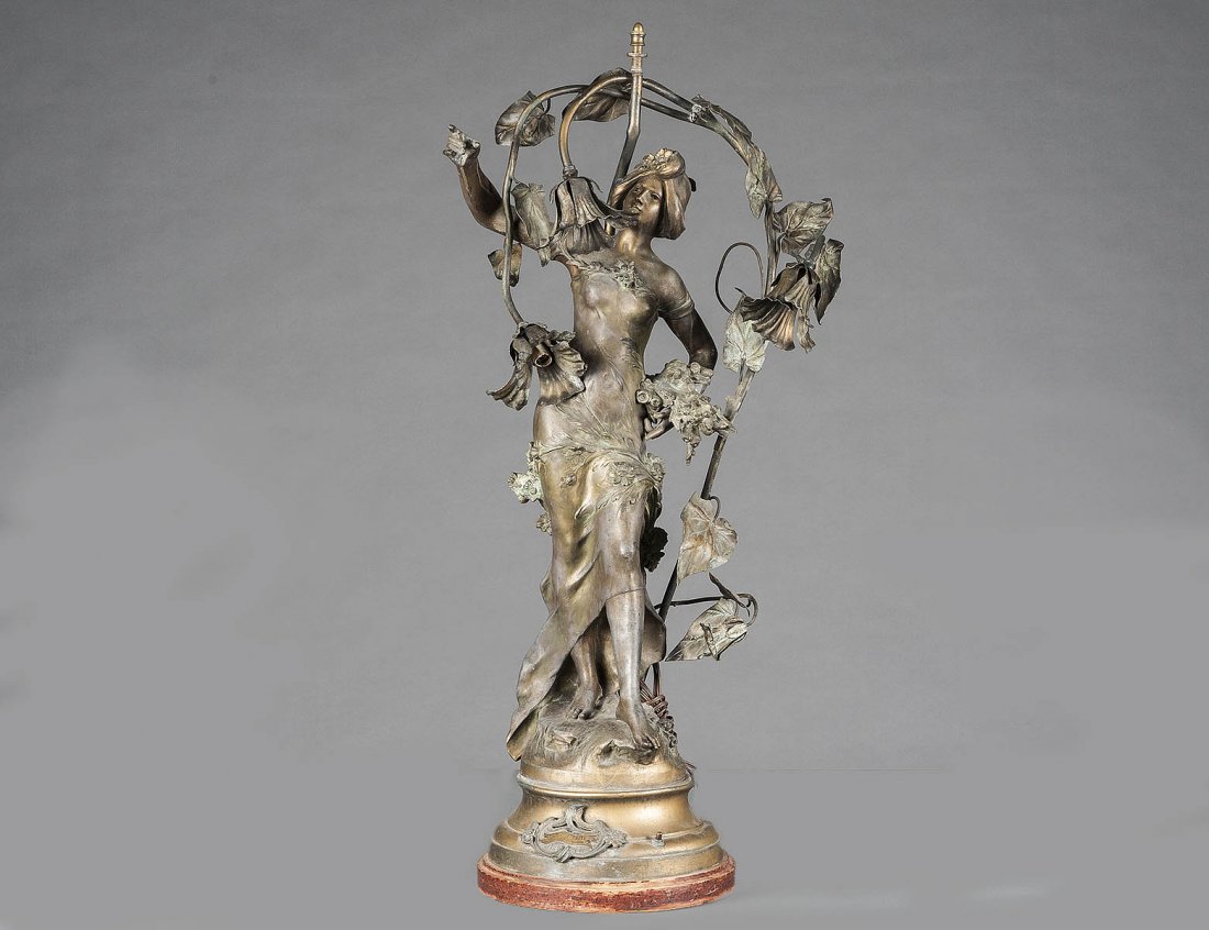 ART NOUVEAU GILT WHITE METAL FIGURAL LAMP: French. Circa 1915. After the original by Aug. Moreau. With plaque inscribed “Les Marguerites”. Height 38 ¼”. (600/800)