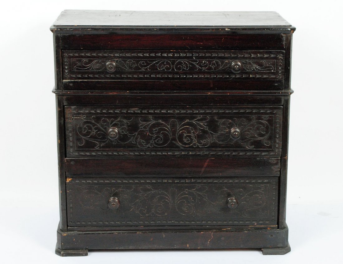 RENAISSANCE STYLE CARVED AND EBONIZED WOOD CHEST OF DRA: Spanish. The low rectangular case fitted with three long drawers. Height 20 1/4". Width 20 3/4". Depth 10 3/8". (200/300)
