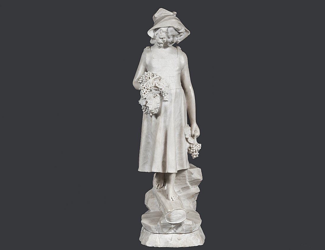 CARVED MARBLE FIGURE OF A GIRL: Italian. Holding cluster of grapes and walking on a log. Height 32 3/4". (2000/3000)