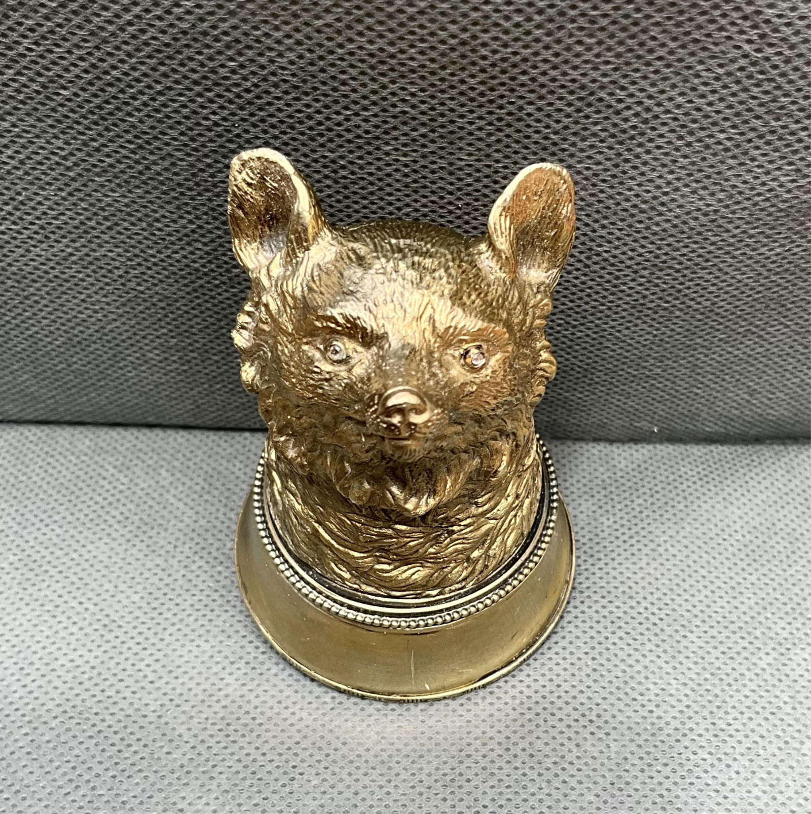Russian Gilded Silver and Enamel Fox Head Pill Box set with rose cut diamond eyes. The underside: Russian Gilded Silver and Enamel Fox Head Pill Box set with rose cut diamond eyes. The underside mounted with two sapphires and ruby stones on an enamel ground, the inside of the box stamped 84 with t