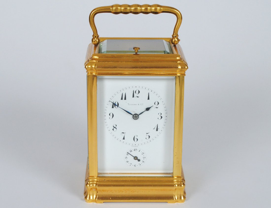 TIFFANY & CO. GRAND SONNERIE BRASS CARRIAGE CLOCK: French. Late 19th Century. Dial signed Tiffany & Co., France. With subsidiary alarm, repeat button and selection lever in base. Height 6". (2500/3500)