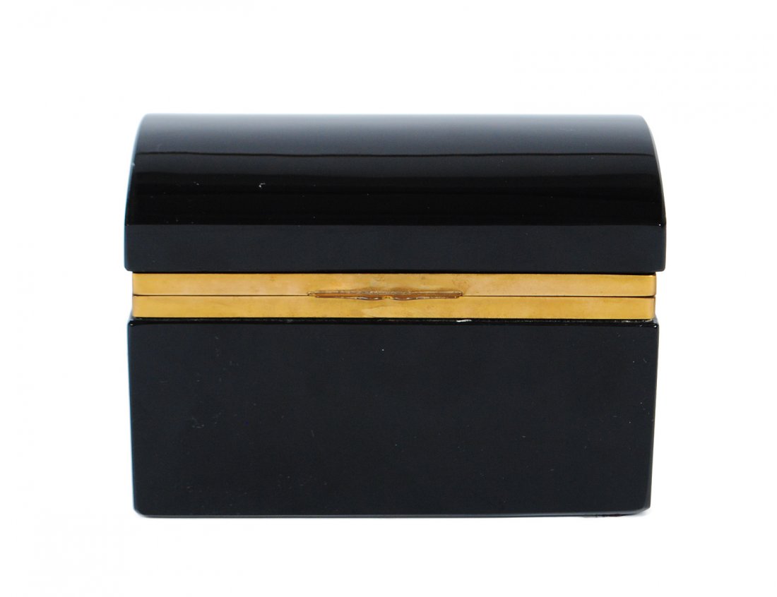 BLACK OPALINE GLASS BOX: French. 20th Century. With hinged dome cover, mounted with brass rims. Length 5 1/4". (500/600)