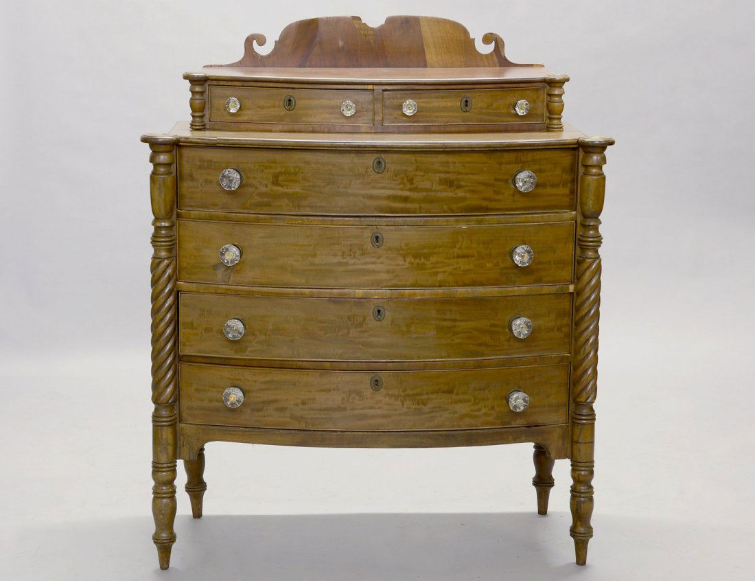 VICTORIAN MAHOGANY CHEST OF DRAWERS: American. Mid 19th Century. The bow fronted case with a superstructure containing two short and four long drawers flanked by spiral turned pilasters continuing to form legs. Height 44". Width 41". Dep