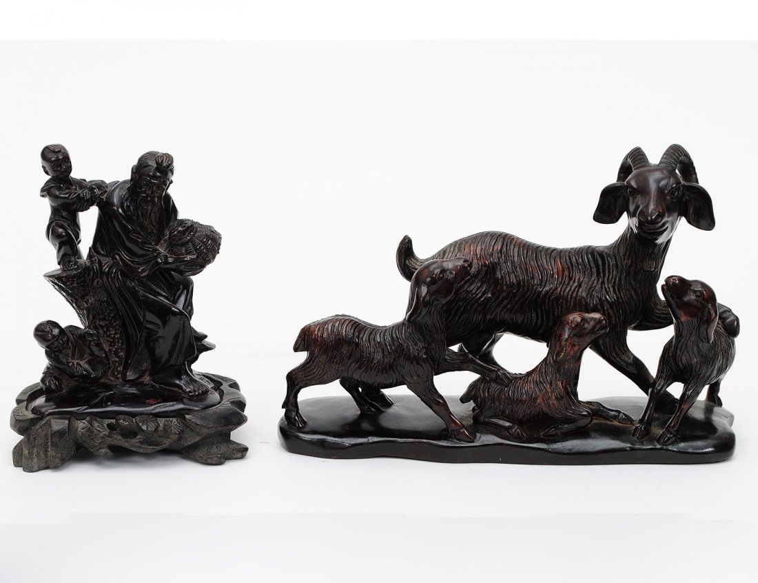 TWO CARVED SOAPSTONE GROUPS: Chinese. The first of an elder with two young attendants. Height 5". On a wood base. The second of a group of deer. Length 8 3/4". With wood stand. (100/500)