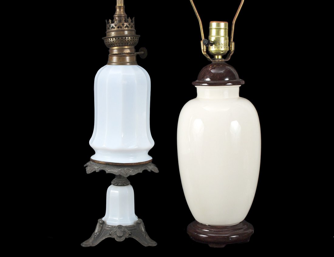WHITE OPALINE GLASS KEROSINE LAMP: American. Circa 1900. With patinated metal mounts. Height 26 3/4". Together with a white glazed porcelain table lamp. Height 22 1/2". (2 pcs) (100/500)