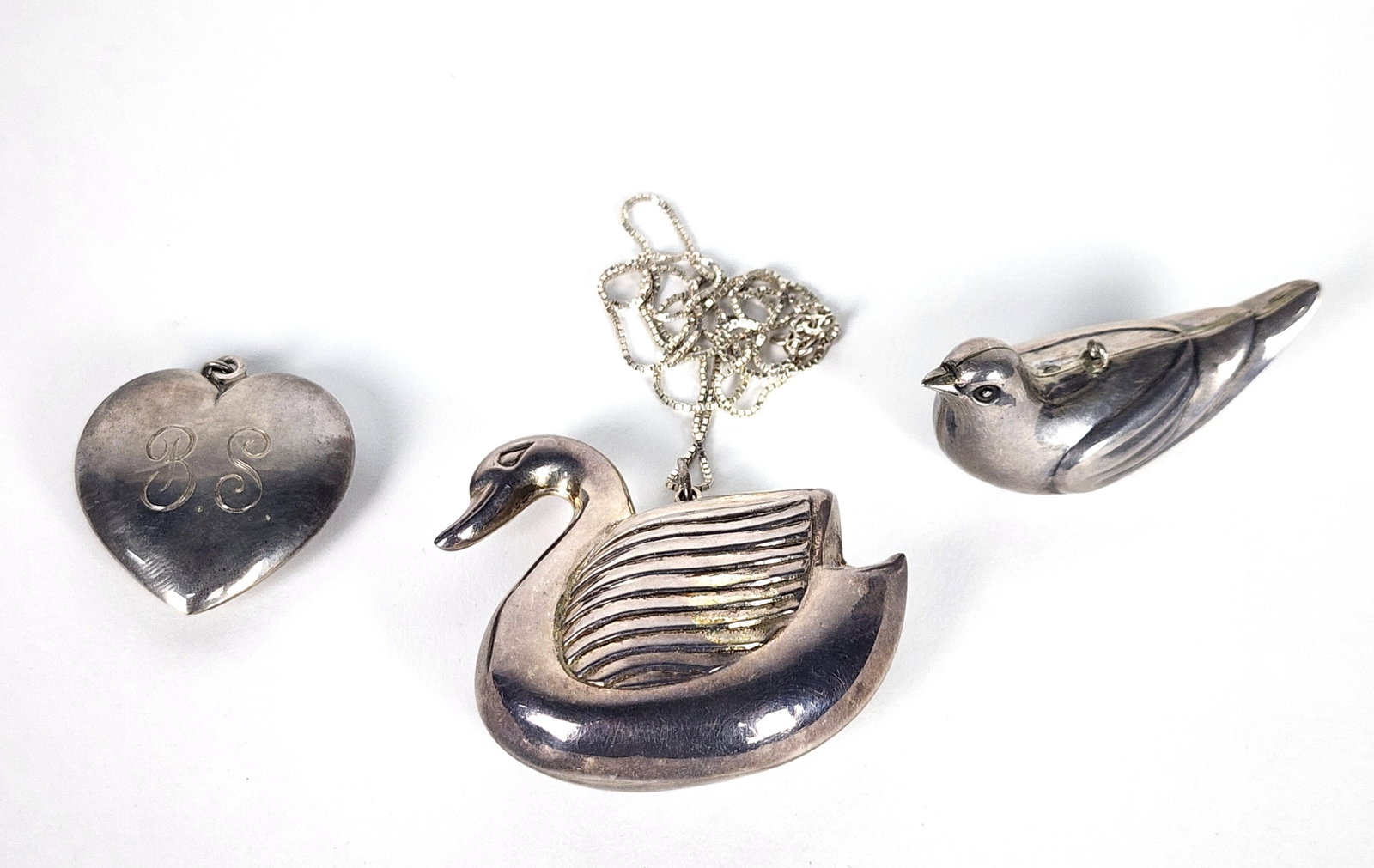 Three Silver Small Objects to include: Heart, Swan, Bird, each approx. 2" x 2" (1 of 8)