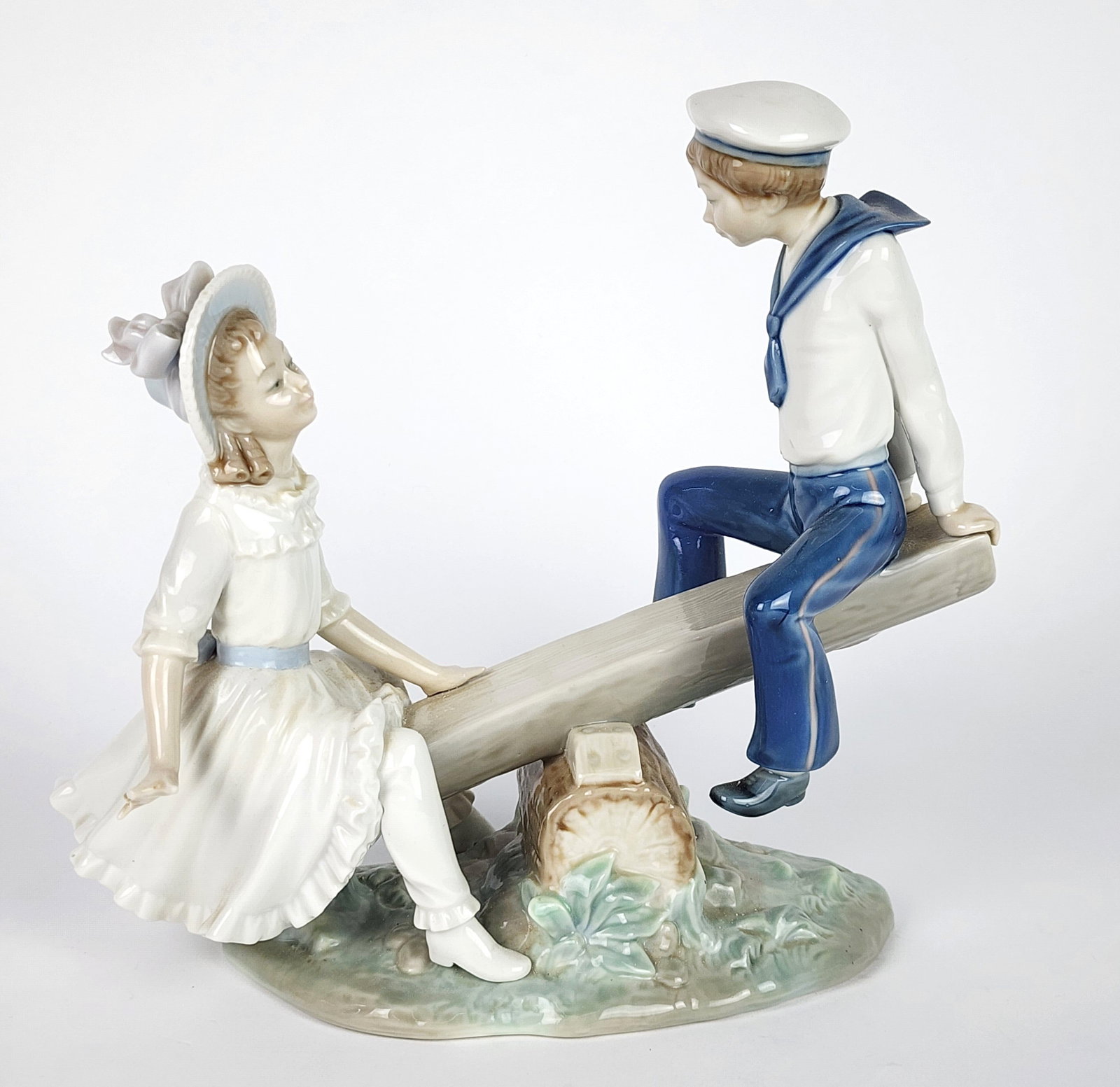 Lladro Porcelain Figure of a Boy and Girl on a Seesaw, underside marked, 9" h. 10 1/2" w. 4" d. (1 of 5)
