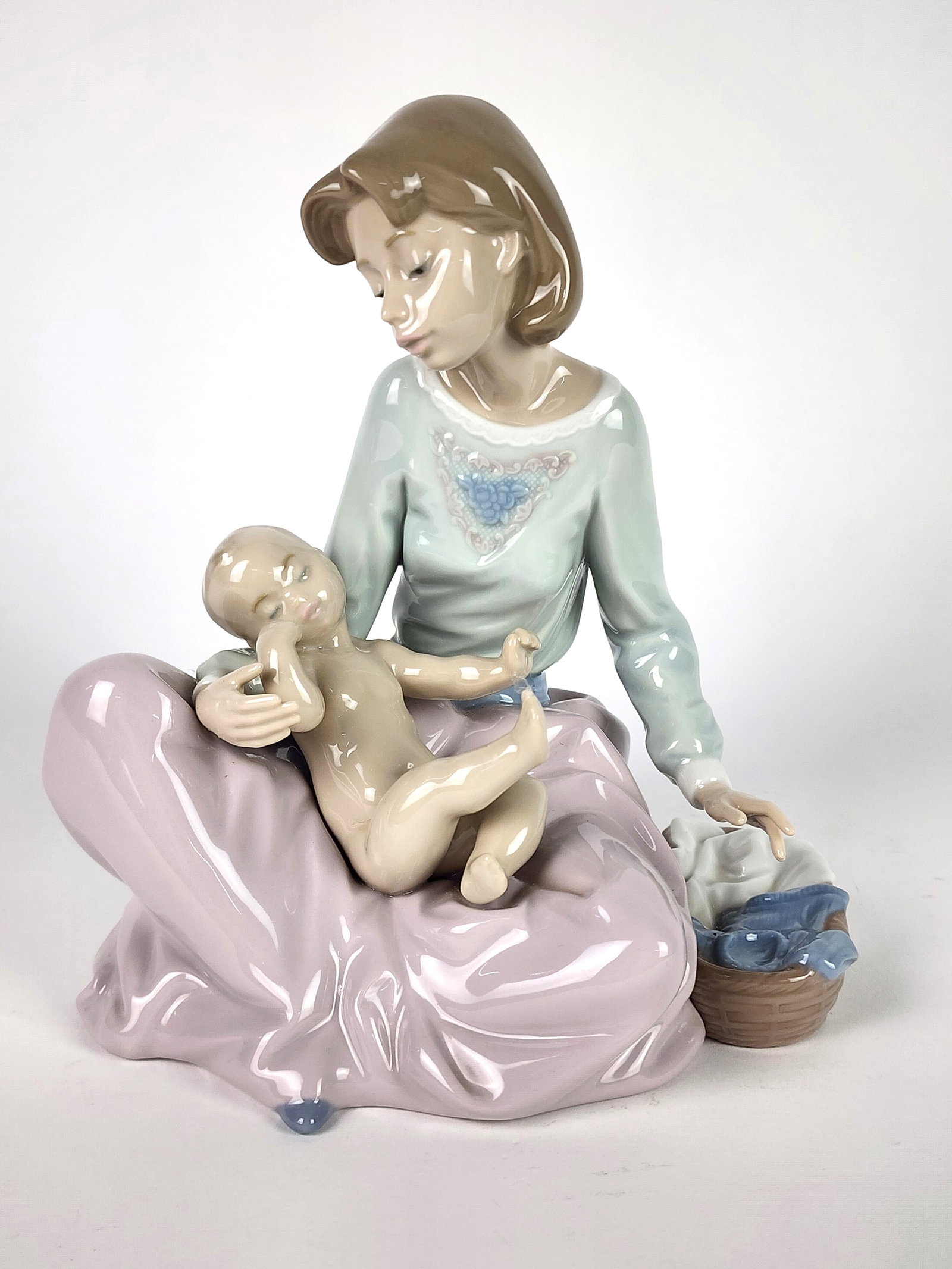 Lladro Porcelain Figure of a Girl and Baby, underside marked,: Lladro Porcelain Figure of a Girl and Baby, underside marked, 7" h. 6 1/2" w. 5 1/4" d.