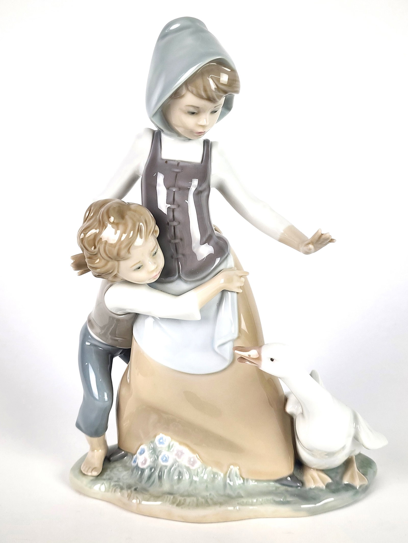 Lladro Porcelain Figure of a Boy and Goose, underside marked, 10" h. 7" w. 3 1/2" d.: Lladro Porcelain Figure of a Boy and Goose, underside marked, 10" h. 7" w. 3 1/2" d.