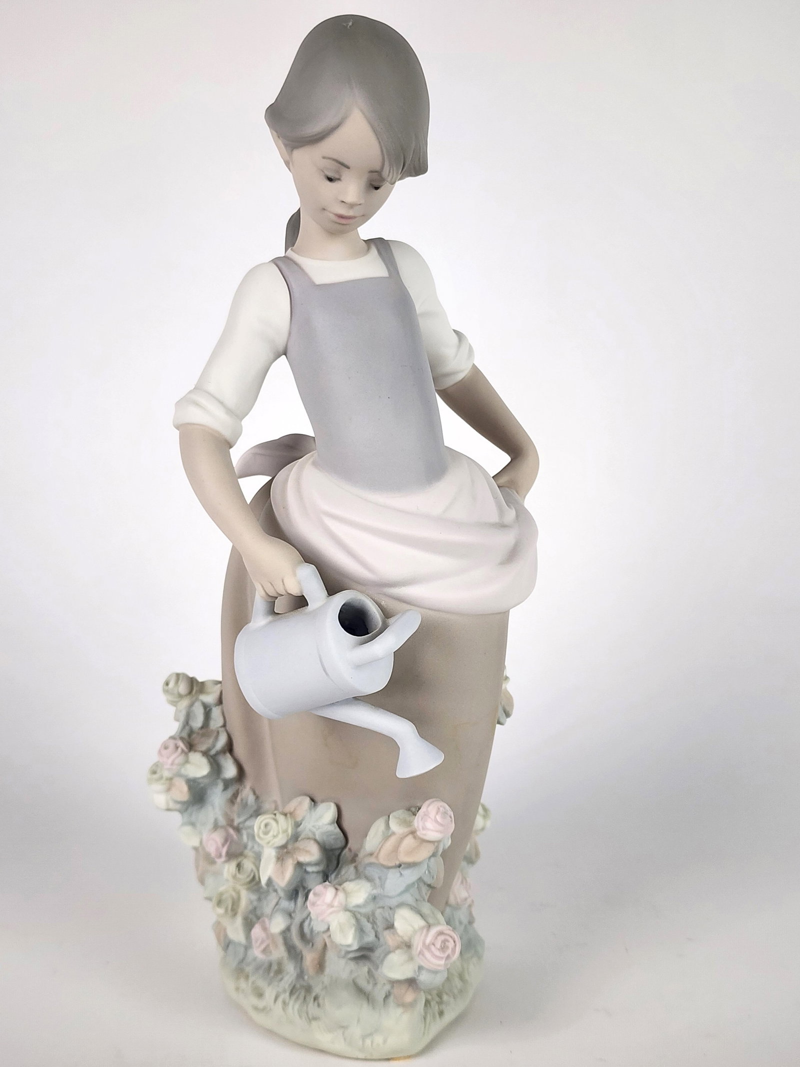Lladro Porcelain Figure of a Girl Watering Flowers, underside marked, 11 1/4" h. 3 1/4" w. 3 3/4" d. (1 of 4)