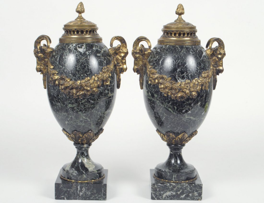 PAIR OF EMPIRE STYLE GILT BRONZE MOUNTED MARBLE: Each with ram's mask handles, raised on a square base. Height 17 1/2". (600/800)