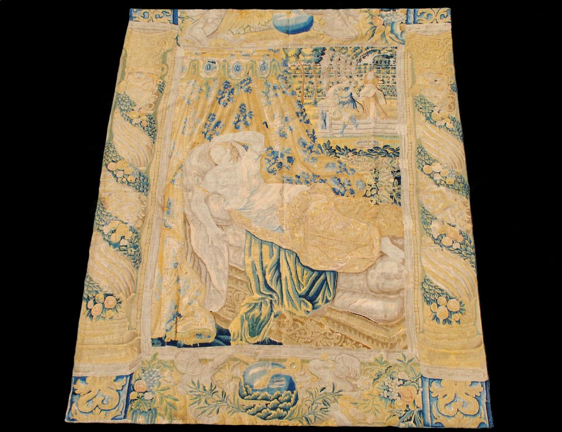 FLEMISH TAPESTRY: 18th Century. Depicting a female reclining on a chaise under a canopy in a garden. Measuring 9'8" by 7'10". (2000/3000)