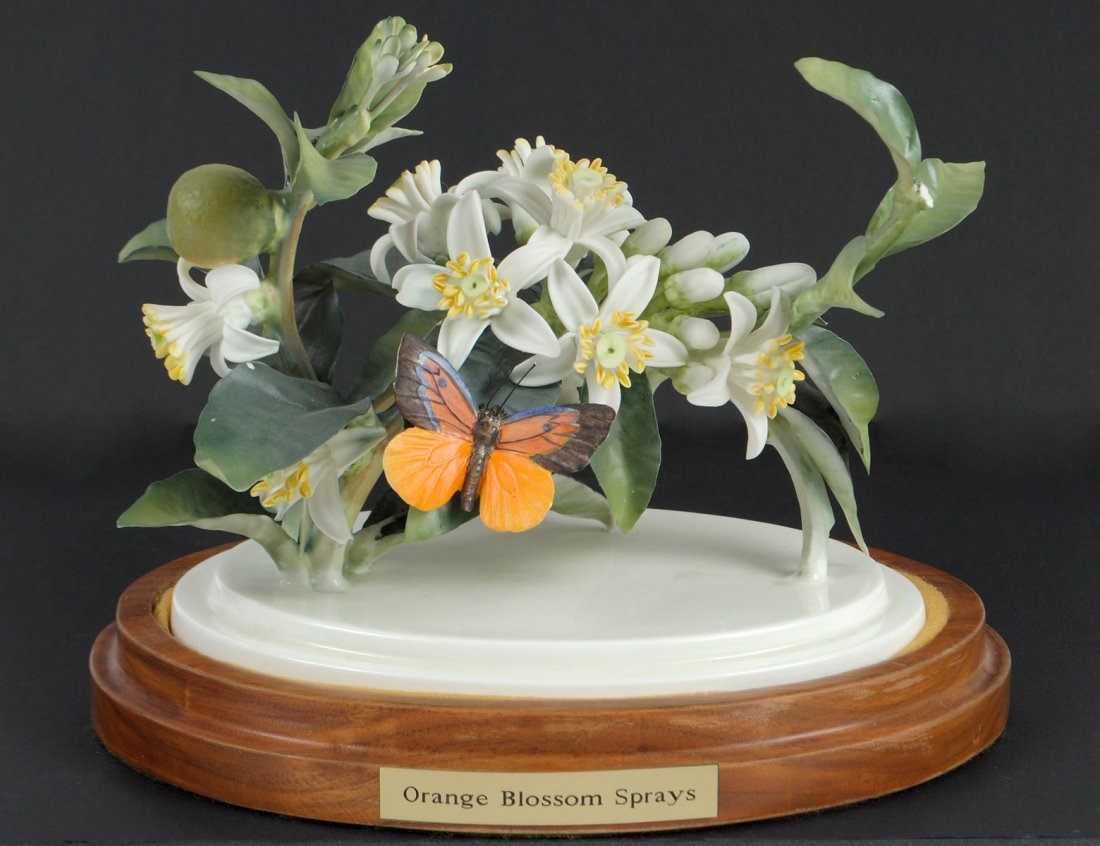 D. DOUGHTY PORCELAIN "ORANGE BLOSSOM & BUTTERFLY": English. 1942. By Royal Worcester. Limited Edition of 175. With wood stand. Length 7 3/8". (Cond: losses) (300/400)