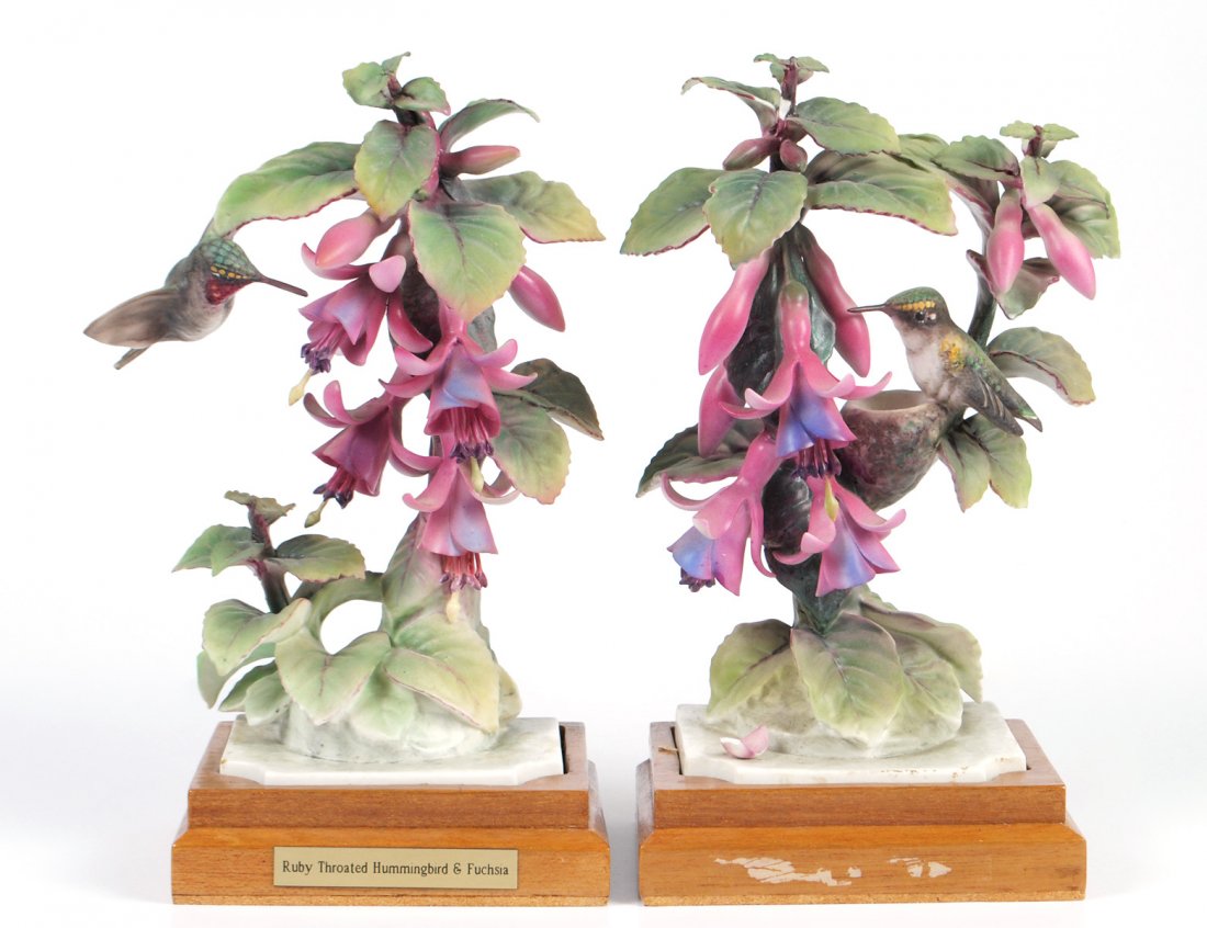 PAIR OF D. DOUGHTY PORCELAIN "RUBY THROATED HUMMINGBIRD: English. 1949. By Royal Worcester. Limited Edition of 500. Heights 9" and 9 5/8". With wood bases. (Cond: two leaves missing) (500/700)