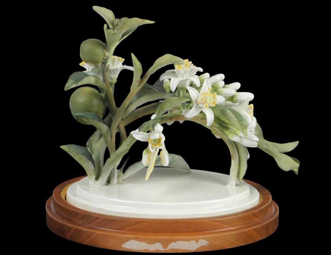 D. DOUGHTY PORCELAIN "ORANGE BLOSSOM SPRAY": English. 1947. By Royal Worcester. Limited Edition of 175. With wood stand. Length 9 1/4". (Cond: minute losses) (150/200)