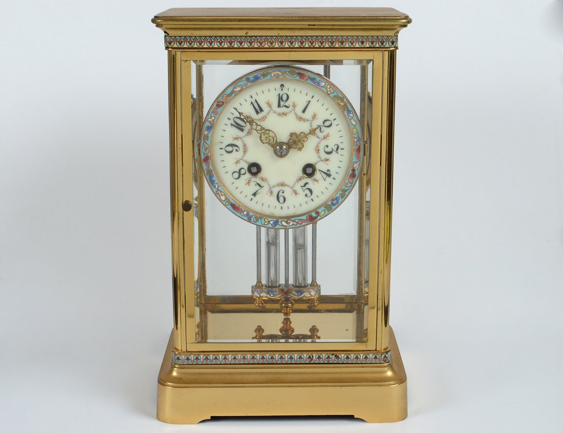 GILT BRONZE AND CHAMPLEVE GLASS CASE CLOCK: French. Circa 1900. Movement stamped Marti & Cie. The dial with Arabic numerals. Height 11 1/8". (400/600)