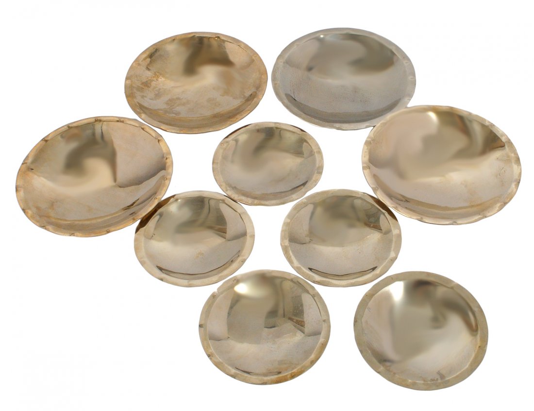 SET OF NINE STERLING SILVER BOWLS: Mexican. Each raised on three ball feet. Diameters: five at 5 3/8" and four at 7 1/2". (50 oz) (750/1000)