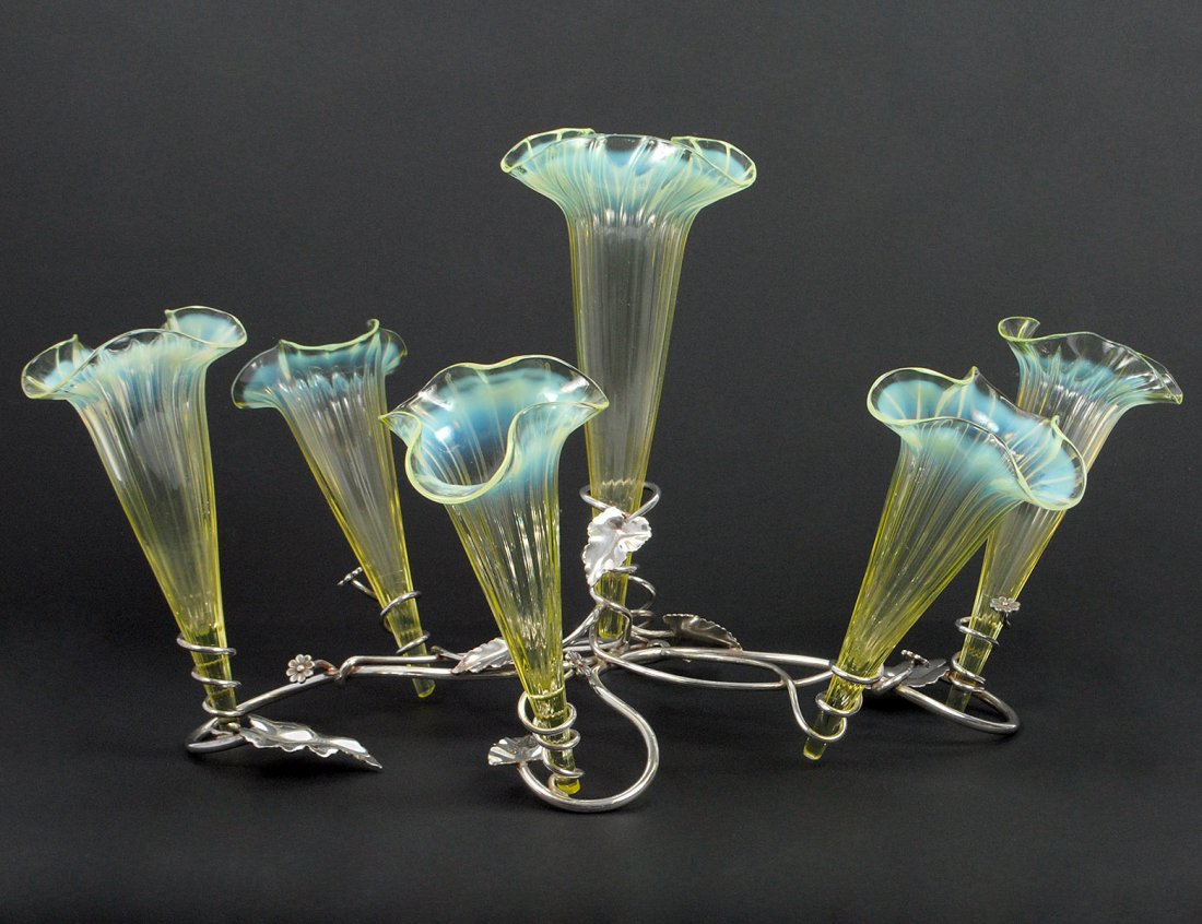 VICTORIAN SILVER PLATED AND GLASS EPERGNE: English. 19th Century. The leafy branch form stand fitted with six glass vase inserts. Height 10 1/4". (Cond: one glass vase missing) (150/250)