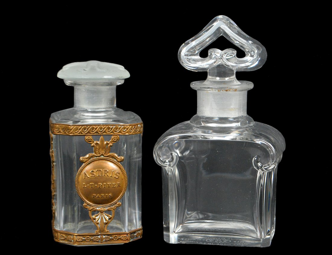 TWO BACCARAT CRYSTAL PARFUME BOTTLES: French. Acid stamped. The first made for Guerlain. Height 4 3/4". The second with metal mounts, L.T. Piver, Paris. Height 3 3/4". (Cond: chip) (100/150)