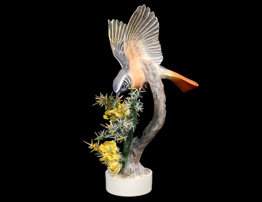 D. DOUGHTY PORCELAIN "REDSTART RUTICILLA": English. 1948. By Royal Worcester. Height 10 5/8". (Cond: losses to needles) (200/300)