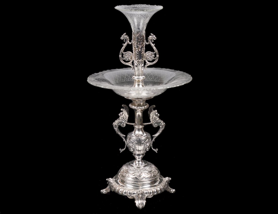VICTORIAN STYLE SILVER PLATED AND ENGRAVED GLASS: Polish. Early 20th Century. By Norblin & Co., Warszawa. With winged lion handles, fitted with a tray and vase. Height 18 1/4". (300/400)
