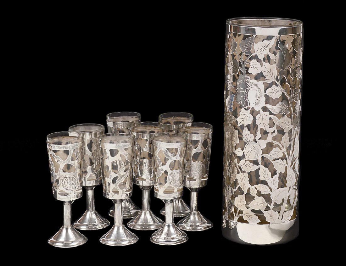 STERLING SILVER AND CLEAR GLASS VASE: Mexican. Of cylindrical form. Height 7 1/8". Together with eight sterling silver and glass shot glasses. Height 3 1/2". (9 pcs) (200/300)