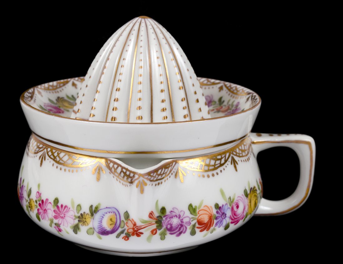 DRESDEN PORCELAIN LEMON JUICER: German. 20th Century. The low single handled cup supporting the pierced and ribbed extractor. Height 3". (200/300)