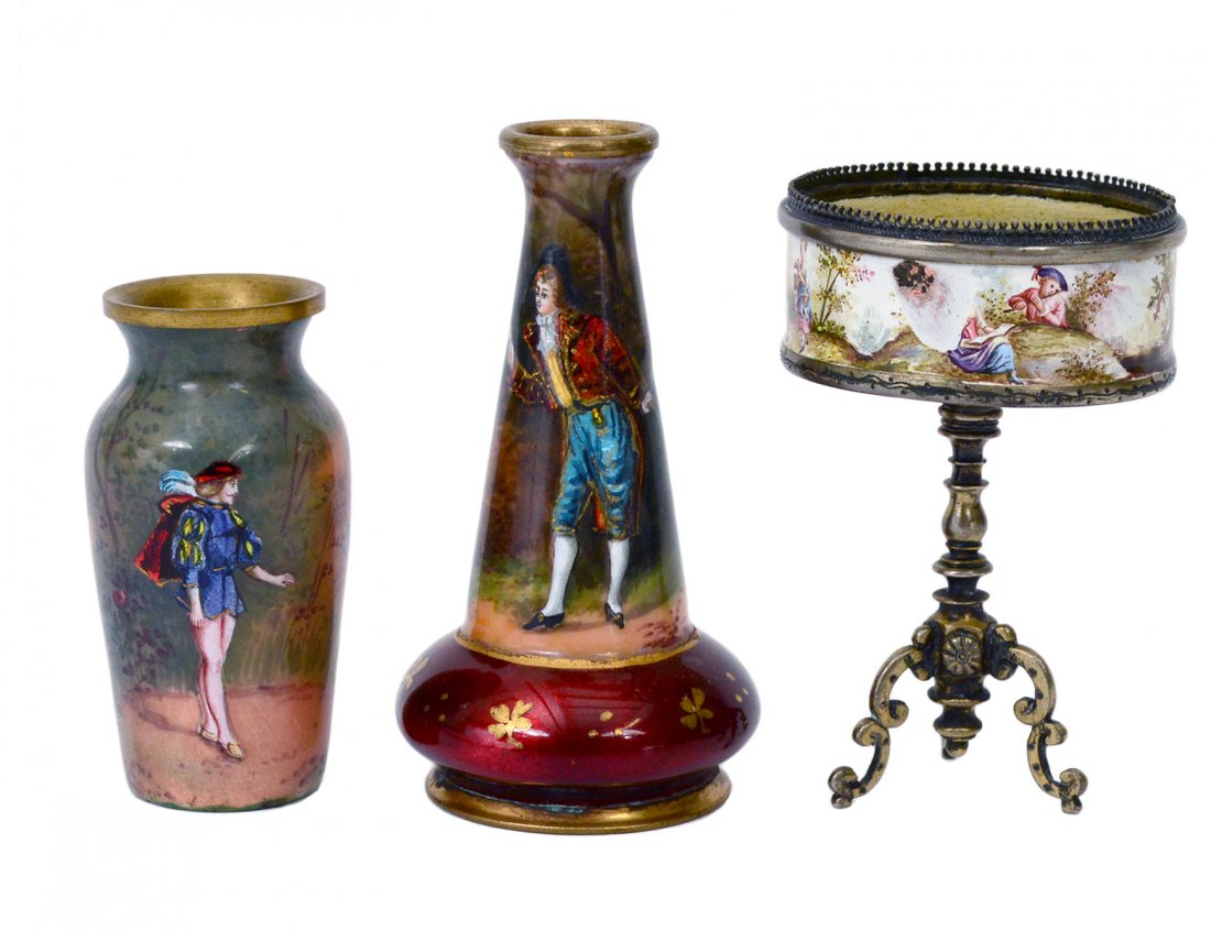 GROUP OF THREE ASSORTED ENAMEL CABINET PIECES: Comprising: two French Limoges bud vases, one signed. Heights 2 1/4" and 3". And a Viennese enamel, silver and metal pedestal salt cellar. Height 2 1/2". (400/500)