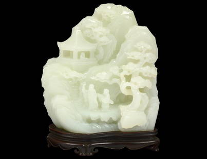 VERY FINE WHITE JADE MOUNTAIN: Chinese. Carved with an elder and attendant crossing a bridge on their way to a temple. Height 5 3/4". With wood stand. (30000/40000) Provenance: Spink & Son, London