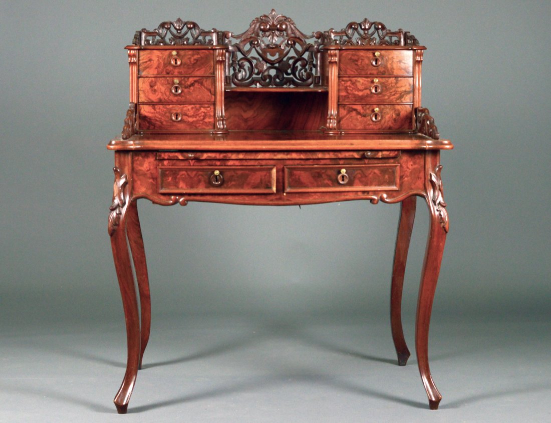 LOUIS XV STYLE WALNUT AND BURL DESK: French. Circa 1920. With a superstructure fitted with drawers and pierced gallery above two frieze drawers, raised on cabriole legs. Height 47". Width 39". Depth 26 1/2". (500/700)