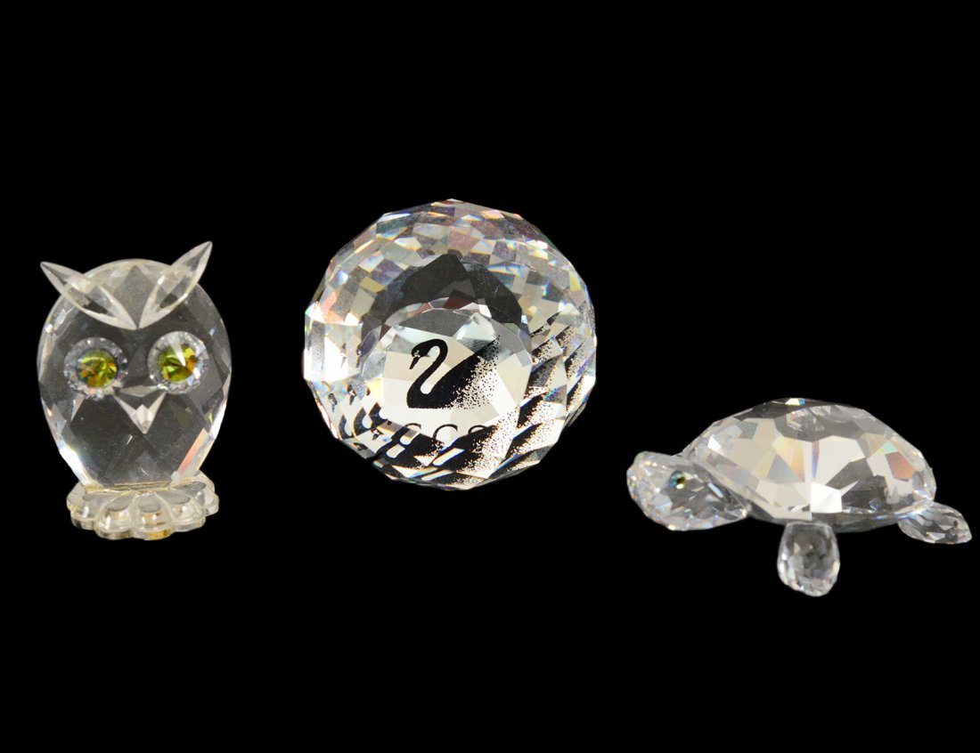 GROUP OF THREE SWAROVSKI CRYSTAL ARTICLES: Comprising: golf ball, owl and a turtle. Each in original box. (100/150)