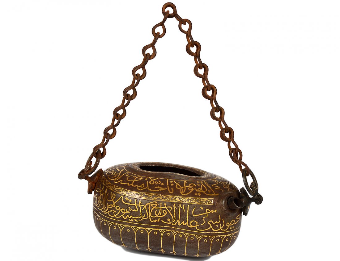 GOLD INLAID BEGGAR'S BOWL: Middle Eastern. Circa 1940. The shaped vessel with metal chain. Length 6 3/4". (500/600)