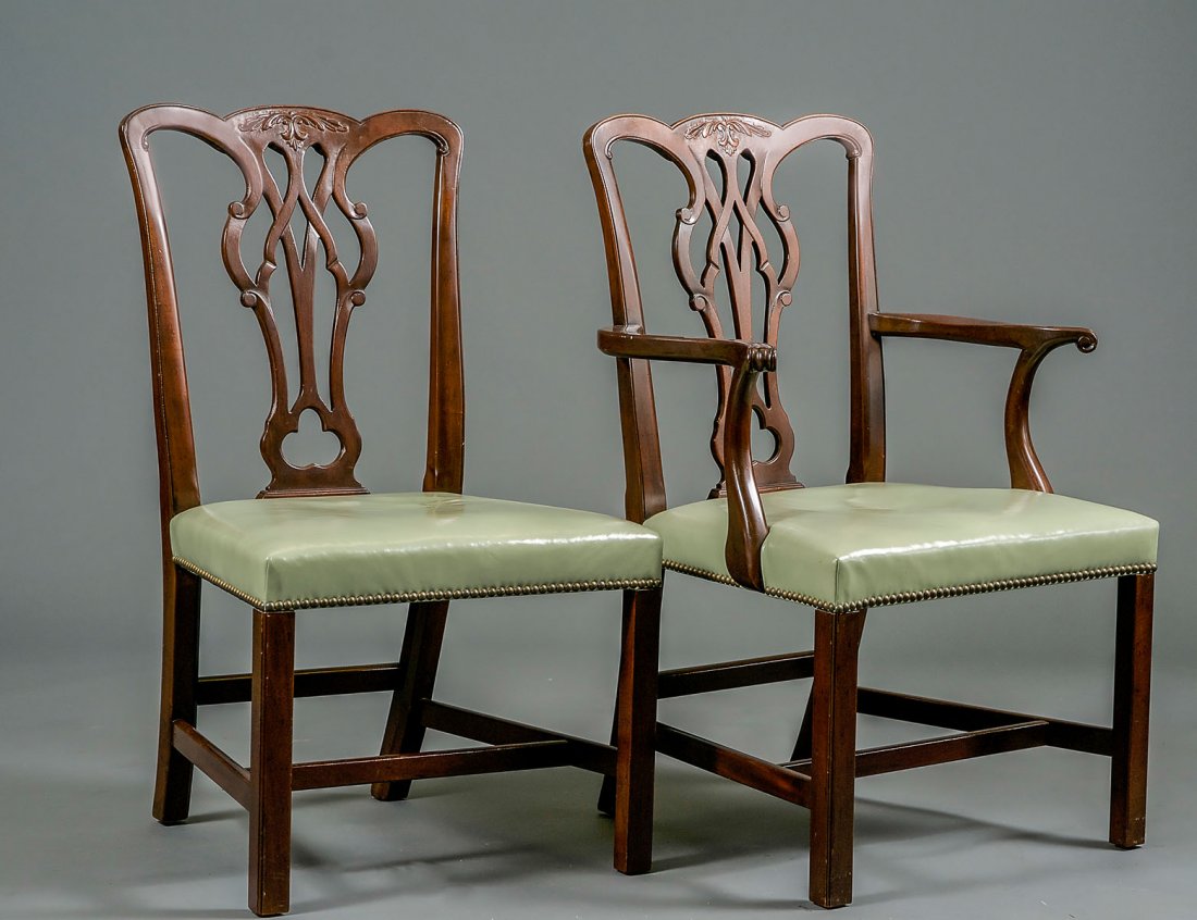 SET OF TWELVE KITTINGER MAHOGANY DINING CHAIRS: Comprising: ten sides and two arms. Each in the George III style with leather seat. (3000/4000)