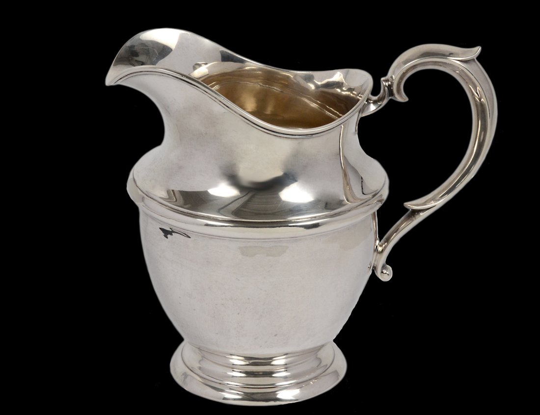 STERLING SILVER WATER PITCHER: American. Maker: Watson. With leaf capped handle. Height 7 3/4". (19 oz) (400/500)