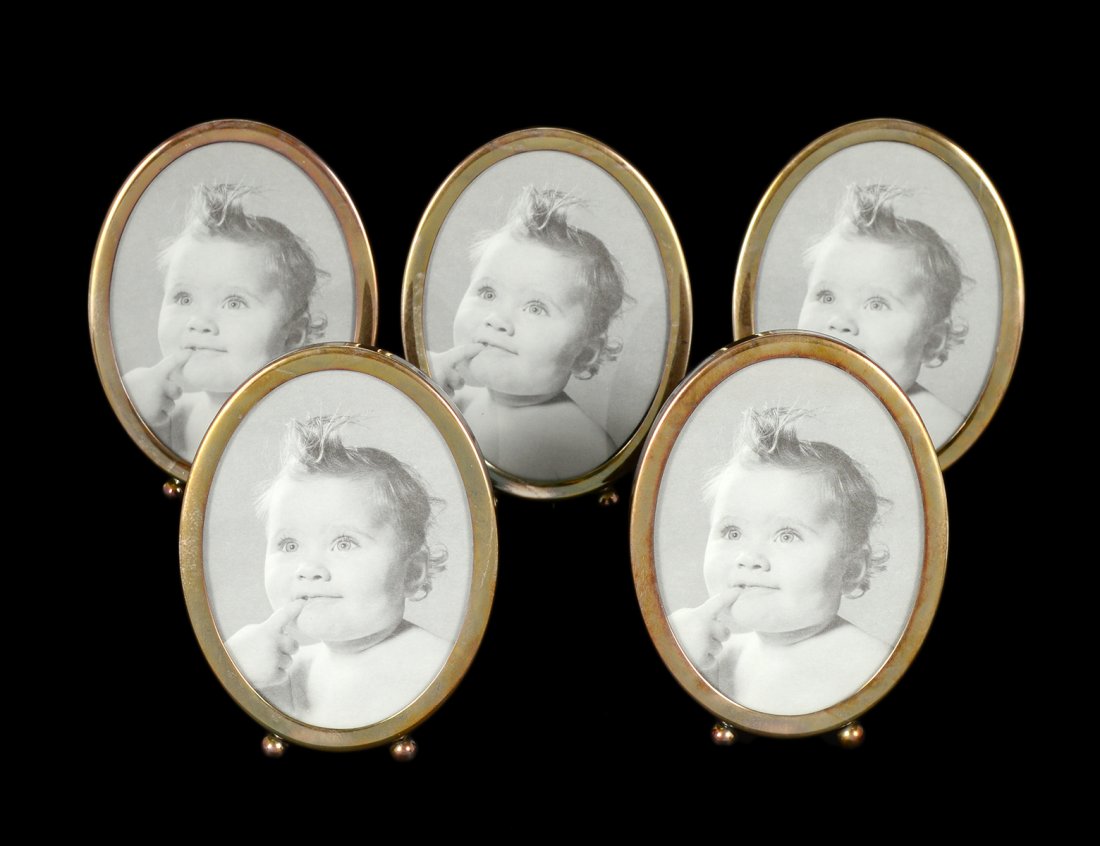 SET OF FIVE STERLING SILVER PHOTOGRAPH FRAMES: American. Maker: Web. Each oval measuring 4 1/2" by 3 1/4". (125/175)