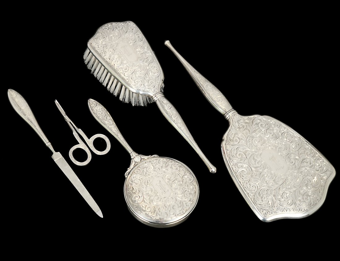 FIVE PIECE BIRKS STERLING SILVER VANITY SET: Canadian. Comprising: two hand mirrors, brush, pair of shears and a file. Each engraved with monogram “L”. (200/300)