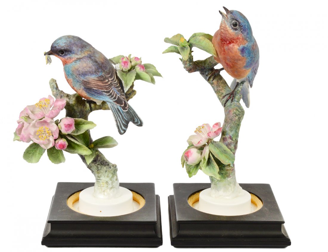 PAIR OF DOROTHY DOUGHTY BLUE BIRDS: English. Dated 1936. By Royal Worcester. Heights 10 1/2" and 8 1/2". With wood stands. (No boxes) (Cond: one leaf restored) (500/700)
