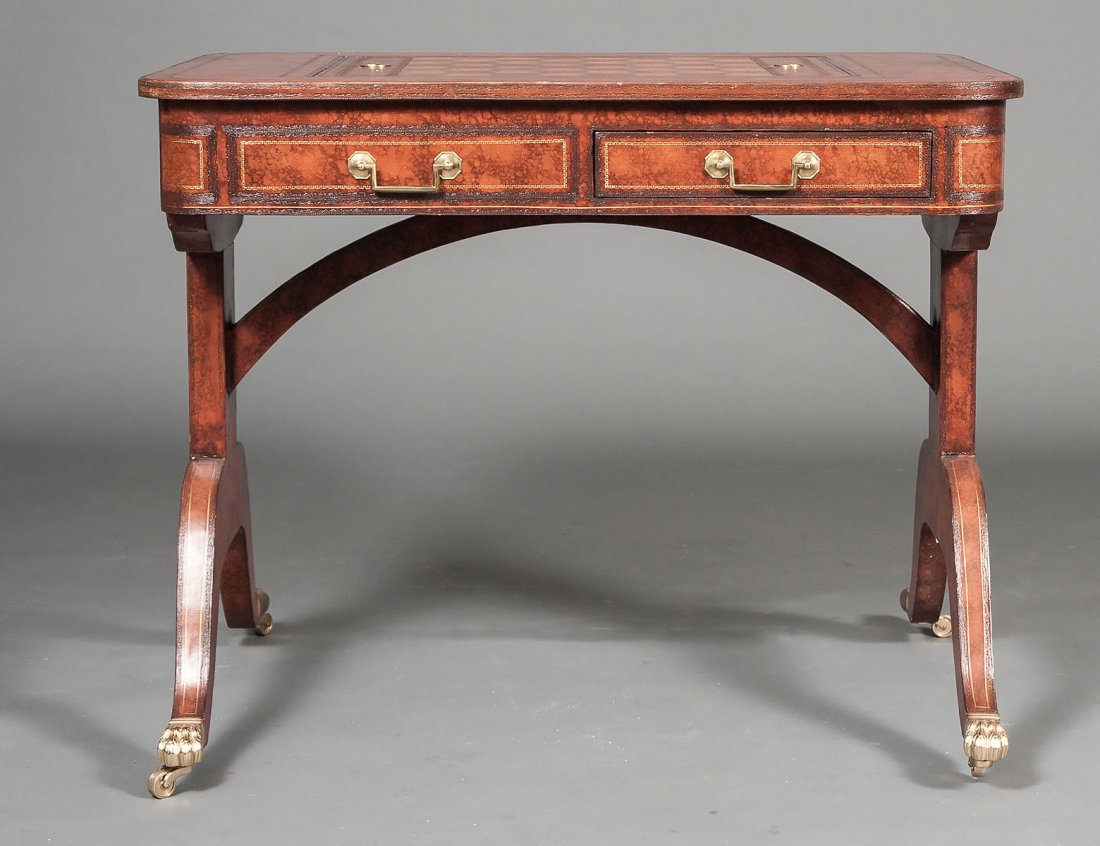 MAITLAND-SMITH TRIC-TRAC TABLE: In the Regency manner with leather top centered by a checker board and backgammon, raised on trestle supports ending in casters. Height 29 3/4". Width 36 3/4". Depth 26". (500/700)