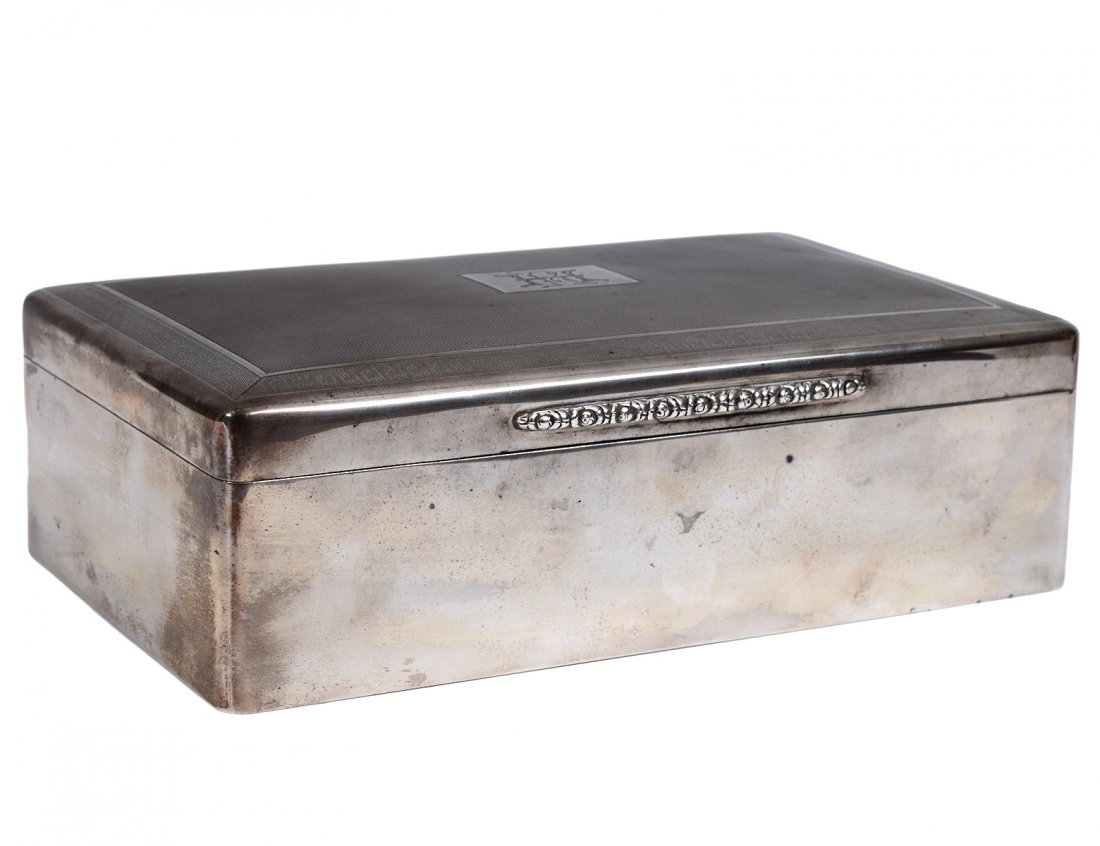 GEORGE V STERLING SILVER CIGARETTE BOX: English. London. 1930. Maker: T.F. & Co. Of rectangular shape with engine turned hinged cover centered by a monogram "HR". Length 9". (300/400)