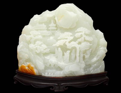 WHITE JADE MOUNTAIN: Chinese. The boulder well carved with figures on a path to a temple. Height 4". With wood stand. (15000/18000) Provenance: Spink & Son, London