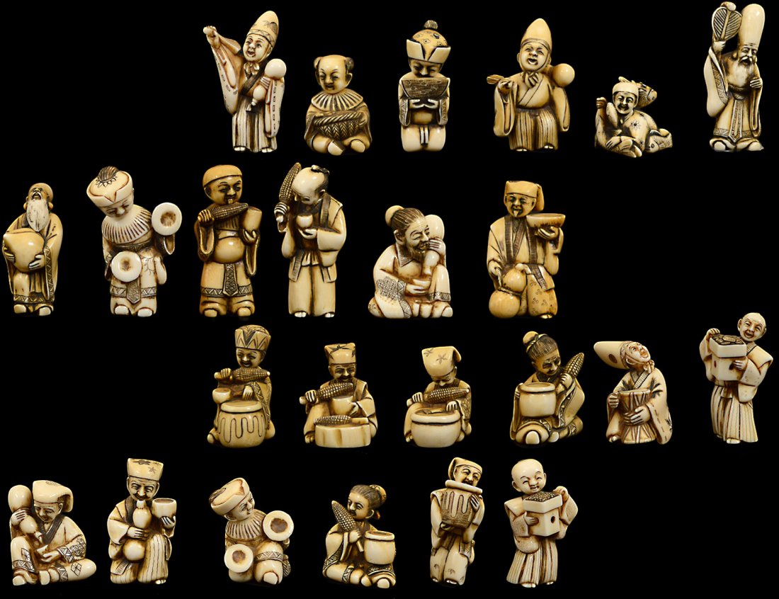 COLLECTION OF TWENTY-FOUR CARVED IVORY NETSUKE: Signed. Some with movable heads. In a presentation case. (500/700) Domestic and International shipping is not available for this item. This item can only be picked up from AGOPB by the buyer and/or th
