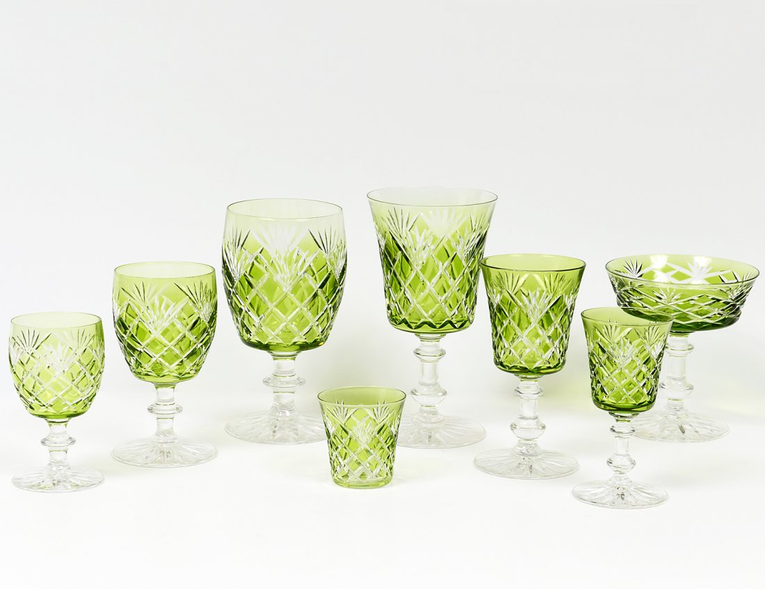 THIRTY-FIVE PIECE GREEN TINTED CUT GLASS PART STEMWARE: Comprising: five water, five wine, five sherry, seven champagne, six liqueur, four port, one shot glass and two small pedestal glasses. (Cond: chips) (200/300)